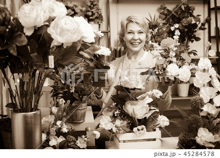 Woman selecting flowers in store Woman selecting flowers in store 45284578