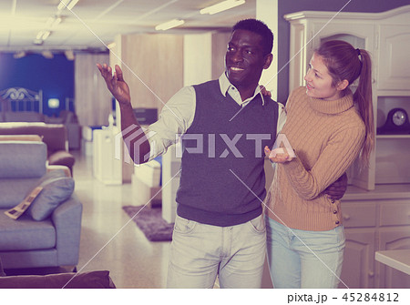 Adult woman with her husband are looking on modern furniture for their house Adult woman with her husband are looking on modern furniture for their house 45284812
