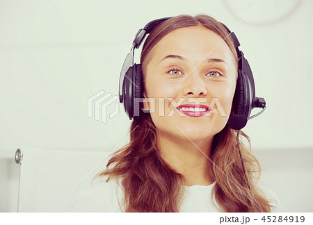 young woman with head set at office. 45284919