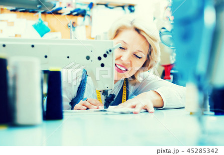 Tailor working on sewing machine Tailor working on sewing machine 45285342
