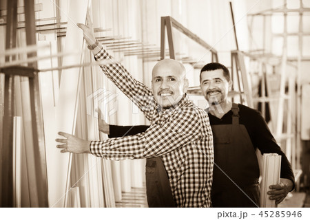 Two PVC industry workers in coveralls . 45285946
