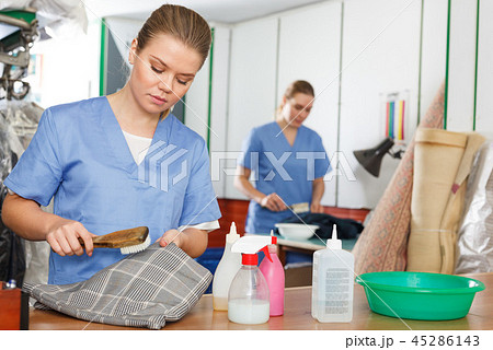 Woman working in dry cleaner Woman working in dry cleaner 45286143