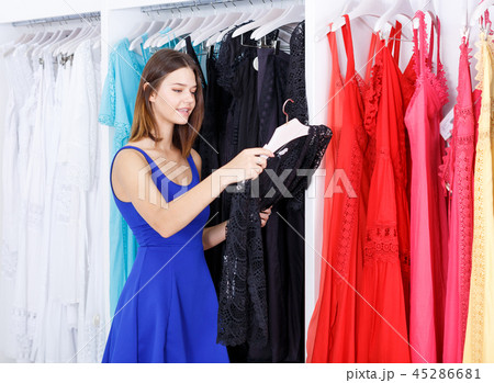 Girl choosing new dress in clothing store 45286681