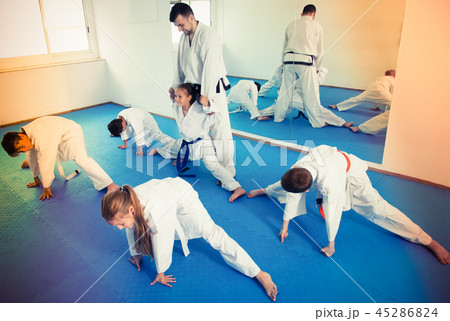 Children stretching before karate class 45286824