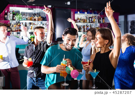 Man with woman are drinking cocktails on corporate party. Man with woman are drinking cocktails on corporate party. 45287207