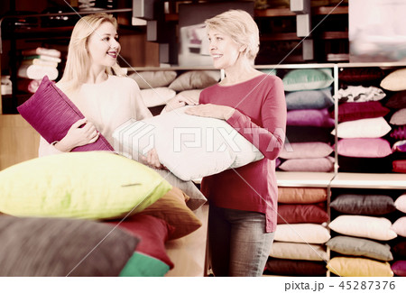 Happy daughter and aged mother choosing pillows Happy daughter and aged mother choosing pillows 45287376