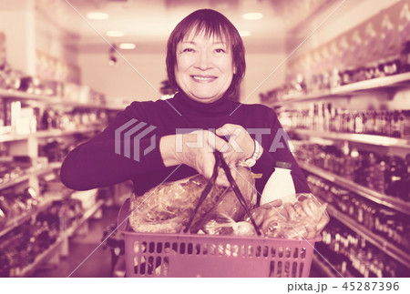consumer in the supermarket choosing food with basket consumer in the supermarket choosing food with basket 45287396