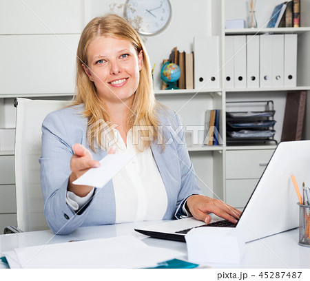 Business woman sitting giving white sticker 45287487
