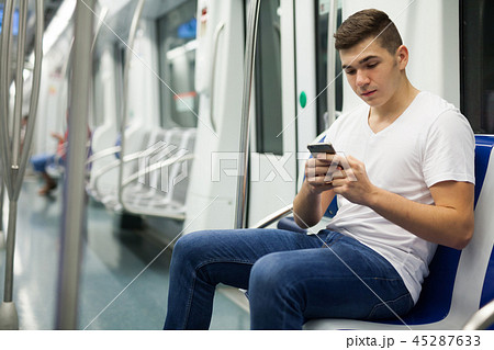 Man with luggage in underground carriage 45287633