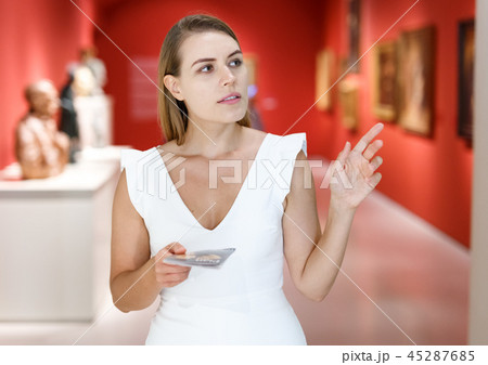 Woman observing museum exposition Woman observing museum exposition 45287685