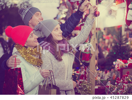 Charming family of three with Christmas decoration 45287829