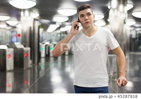 Man traveling on subway and using smartphone 45287918