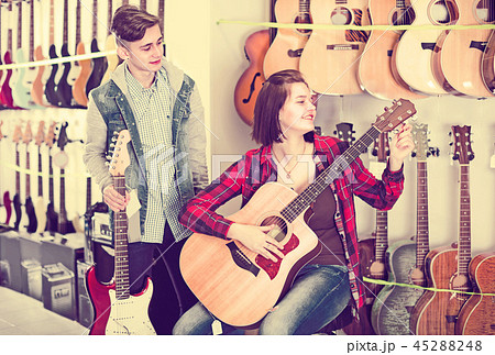 Young rock-n-roll players are choosing between acoustic and electric guitar 45288248