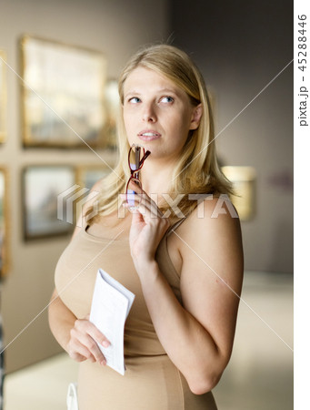 Woman holding brochure in museum of arts Woman holding brochure in museum of arts 45288446