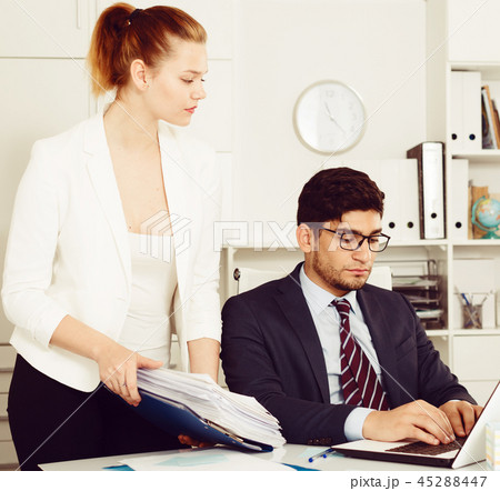 Office worker shocked by stack of papers Office worker shocked by stack of papers 45288447
