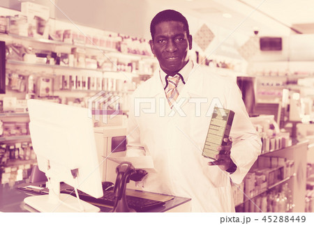 Portrait of experienced male pharmacist counseling about medicines in pharmacy 45288449