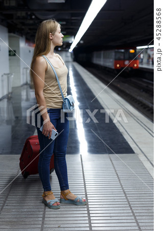Woman on underground platform waiting train 45288568