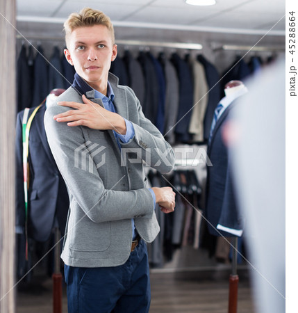 Male in suit trying jacket in the clothes store 45288664