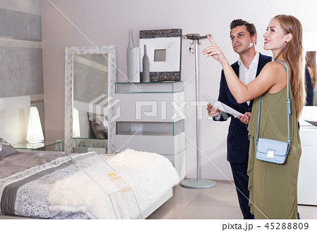 Family couple visiting salon of furniture Family couple visiting salon of furniture 45288809