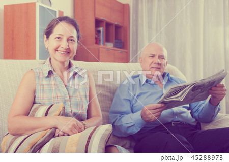 Happy couple of grandparents with newspaper Happy couple of grandparents with newspaper 45288973