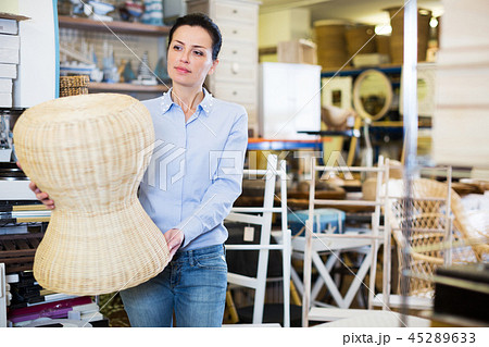 Female choosing straw pouf Female choosing straw pouf 45289633