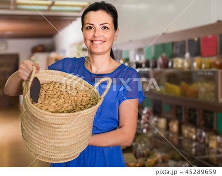 woman displayed big shopping bag with nuts in eco market 45289659
