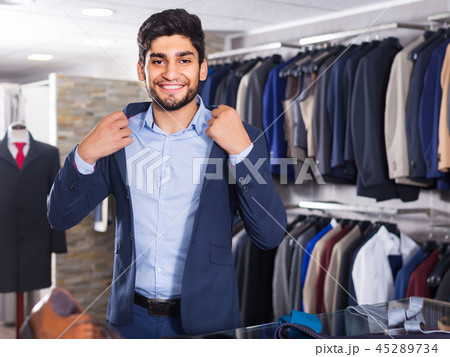Visitor is trying on jacket 45289734
