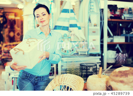 Woman standing with wooden box 45289739
