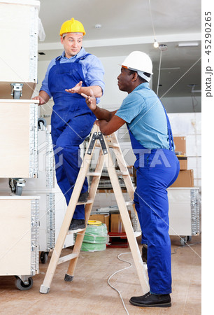 Two male builders working at indoors building site Two male builders working at indoors building site 45290265