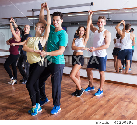 Dancing couples learning salsa Dancing couples learning salsa 45290596