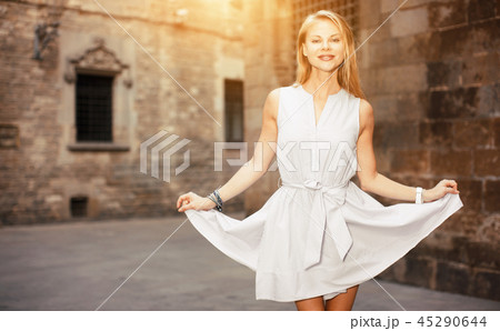 smiling woman holding dress in the hand smiling woman holding dress in the hand 45290644