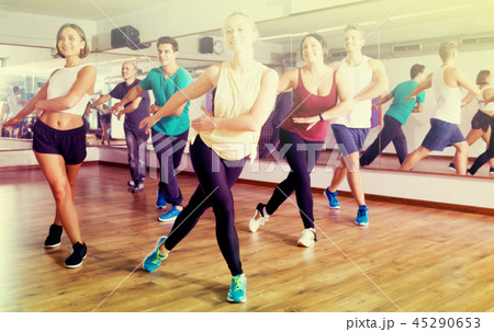 Adults having group fitness class Adults having group fitness class 45290653