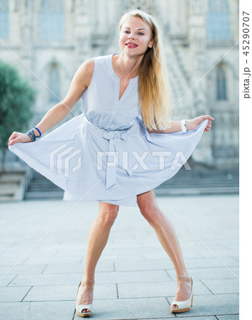 Glad female moving at the street in summer 45290707