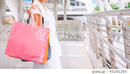 Happy woman with shopping bags enjoying in shop 45291265