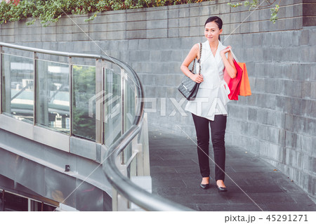 Happy woman with shopping bags enjoying in shop 45291271