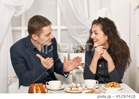 romantic couple drinking tea with cookies 45297410