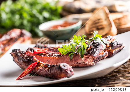Carbecue grilled pork ribs with chili pepers. 45299313