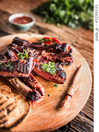 Carbecue grilled pork ribs with chili pepers. 45299331