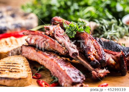 Carbecue grilled pork ribs with chili pepers. Carbecue grilled pork ribs with chili pepers. 45299339