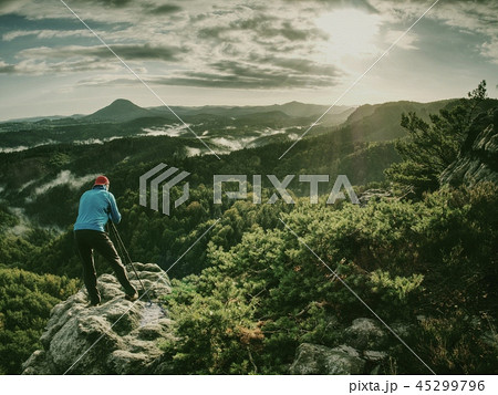 Silhouette of photographer at work during sunset 45299796