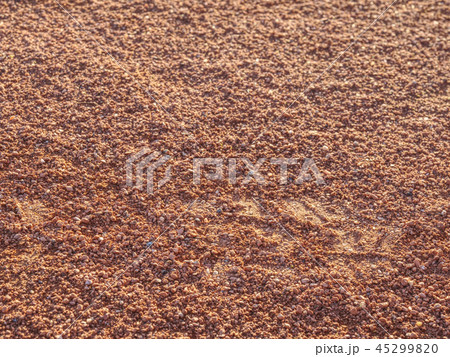 Shoe footprint on tennis clay court. Light surface 45299820