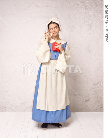 Medieval Woman in Historical Costume Wearing Corset Dress and Bonnet. Medieval Woman in Historical Costume Wearing Corset Dress and Bonnet. 45299900