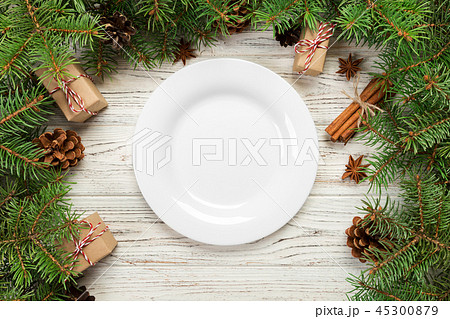 Empty plate on wooden christmas background Empty plate on wooden christmas background 45300879