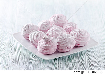 lovely pastel rose meringues, zephyrs, marshmallows on the wooden vintage table 45302132