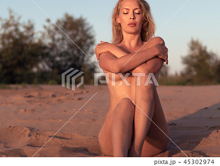 Beautiful girl model on sandy beach of the sea Beautiful girl model on sandy beach of the sea 45302974
