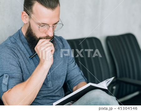 focused man reading notepad business data analysis 45304546