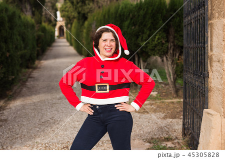 Christmas and holiday concept - Happy woman having fan in Santa Claus costume Christmas and holiday concept - Happy woman having fan in Santa Claus costume 45305828