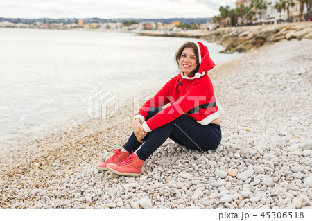 Christmas and holidays concept - dreaming woman in santa costume on sandy beach 45306518