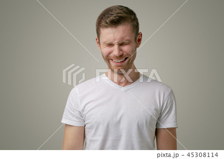 A man has a mournful pitiful expression 45308114