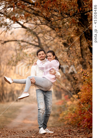 Couple in love in the autumn leaves 45308486